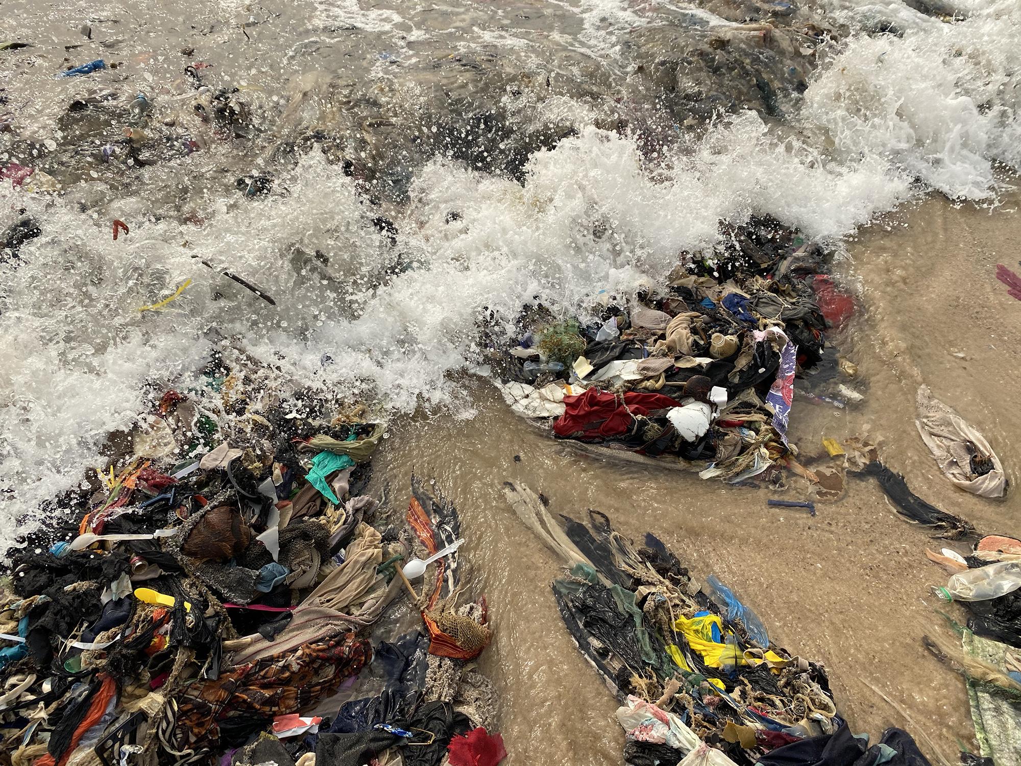 Clothing waste washed up on a beach in Ghana
